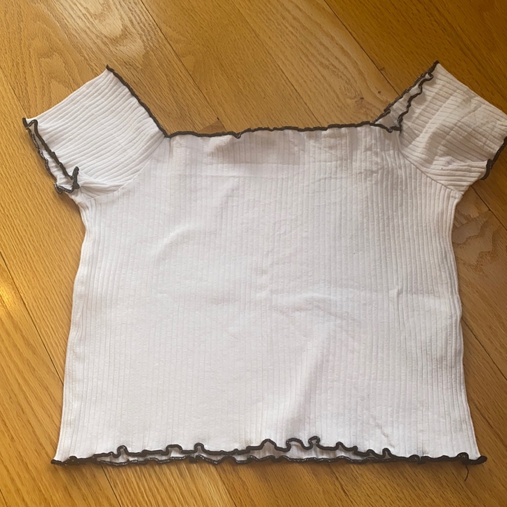 White ribbed crop top with accented black lining.